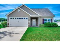 Charming single-Gathering home features a two-car garage, well-manicured lawn, and inviting entryway at 176 Springtide Dr., Conway, SC 29527
