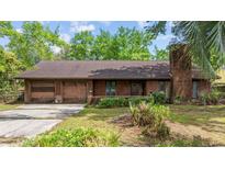 Charming single-story brick home featuring an attached garage and well-maintained landscaping at 219 Caropine Dr., Surfside Beach, SC 29575