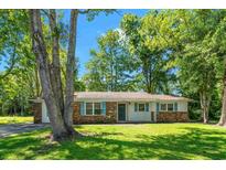 Charming one-story home featuring a brick and white facade with blue shutters and a well-maintained lawn at 4300 Crows Nest Ct., Myrtle Beach, SC 29579