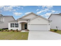 Charming single-story home with white siding, a two-car garage, and a well-manicured lawn at 438 Clear Lake Dr., Conway, SC 29526