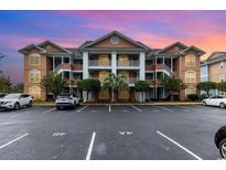 Condominium complex featuring architectural details and well-maintained landscaping at 4633 Lightkeepers Way # 5-F, Little River, SC 29566
