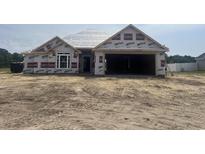 Exterior of a new construction single-Gathering home featuring a two-car garage and covered entry at 475 Highway 348, Loris, SC 29569