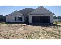 Newly constructed single story home with white siding and an attached two car garage and unfinished yard at 475 Highway 348, Loris, SC 29569