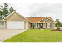 Charming single-story home with a well-manicured lawn and attached two car garage at 550 Bridgeport Dr., Myrtle Beach, SC 29577