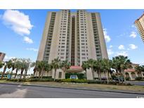Stunning exterior shot of a high-rise condo building with palm trees and lush landscaping on a clear, sunny day at 8560 Queensway Blvd. # 508, Myrtle Beach, SC 29572