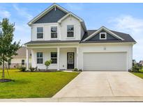 Charming two-story home with a well-manicured lawn, attached garage, and a welcoming front porch at 863 Agostino Dr., Myrtle Beach, SC 29579