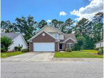 Charming two-story home with a well-manicured lawn and attached two-car garage, perfect for suburban living at 1033 Mccall Loop, Conway, SC 29526