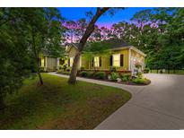 Charming one-story home with manicured landscaping, walkway, driveway, and attached garage surrounded by mature trees at 116 Chapel Ridge Circle, Myrtle Beach, SC 29588