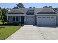 Charming single-story home features a spacious two-car garage and beautifully landscaped front yard at 1258 Halter Pl., Calabash, NC 28467