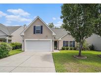 Charming home featuring a two-car garage, well-kept lawn, and mature tree providing ample shade at 140 Avondale Dr., Myrtle Beach, SC 29588