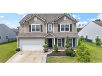 Charming two-story home with neutral siding, black shutters, manicured landscaping, and an attached two-car garage at 148 Long Leaf Pine Dr., Conway, SC 29526