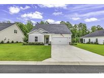 Charming single-story home with a well-manicured lawn and attached two-car garage at 191 Marley Blue Dr., Little River, SC 29566