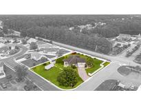 An aerial view of a charming home featuring a lush green lawn and mature trees at 196 La Patos Dr., Myrtle Beach, SC 29588