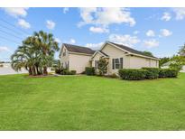Charming single-Gathering home with vinyl siding, lush lawn, and mature palm trees enhancing curb appeal at 196 La Patos Dr., Myrtle Beach, SC 29588