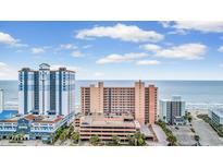 Coastal condo complex featuring beautiful ocean views, multi-story parking, and manicured landscaping at 2207 S Ocean Blvd. # 1517, Myrtle Beach, SC 29577