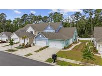 Charming two-story homes feature garages and landscaped yards in a serene community setting at 2475 Blue Crane Circle # 106, Myrtle Beach, SC 29577