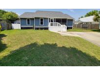 Charming single-story home featuring a screened-in porch and well-maintained front yard at 302 Silver Fox Trail, Myrtle Beach, SC 29588
