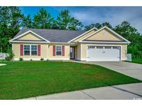Charming single-story home with manicured lawn and attached two-car garage at 3129 Slade Dr., Conway, SC 29526