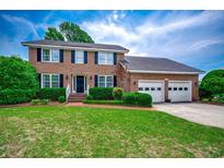 Charming two-story brick home with well-manicured lawn and three car garage at 3334 Cedar Creek Run, Little River, SC 29566