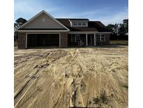New construction brick home with a two car garage, and unfinished landscaping at 3444 Asbury Rd., Aynor, SC 29511
