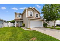 Charming two-story home featuring a spacious front yard, two-car garage, and neutral siding, all under a sunny sky at 4013 Blackwolf Dr., Myrtle Beach, SC 29579