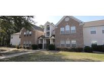 A charming two-story townhome with a manicured lawn and beautiful landscaping at 4319 Lotus Ct. # A, Murrells Inlet, SC 29576