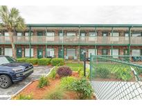 Multi-Gathering building with lush landscaping, covered walkways, and a blue SUV parked out front at 4516 Seaview St. # 137, North Myrtle Beach, SC 29582