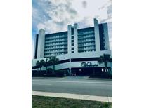 Exterior shot of a multistory condo building, showcasing architecture and entry at 523 S Ocean Blvd. # 705, North Myrtle Beach, SC 29582