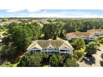 Beautiful aerial view of the condo complex surrounded by lush greenery in a desirable community at 5825 Catalina Dr. # 124, North Myrtle Beach, SC 29582