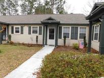 Inviting single story villa with a well-kept lawn and front yard garden at 6805 Creekwatch Rd. # 105, Myrtle Beach, SC 29588