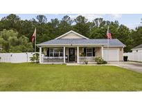 Charming single-story home with a well-manicured lawn, cozy front porch, and attached garage at 721 Dunlon Ct., Myrtle Beach, SC 29588