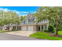 Inviting townhome with a two-car garage, green shutters and a manicured lawn at 751 Painted Bunting Dr. # E, Murrells Inlet, SC 29576