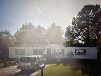 Charming single-story home with mature trees and a well-maintained front yard at 8151 Woodland Dr., Myrtle Beach, SC 29588