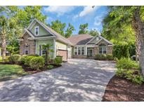 Charming home with a well-manicured lawn, brick accents, and inviting driveway at 840 Jeter Ln., Myrtle Beach, SC 29588
