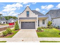 Charming single Gathering home featuring a two-car garage and a well manicured lawn at 8469 Cape Dutch Loop, Myrtle Beach, SC 29572