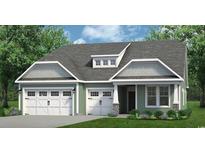 Charming one-story home featuring a two-car garage, covered porch, and light green siding at 934 Parelli Way Nw, Calabash, NC 28467