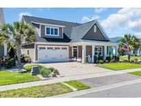 Charming home with a well-manicured lawn, two car garage, and covered front porch at 1145 Captain Hooks Way, North Myrtle Beach, SC 29582