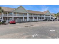 This is an exterior view of the condo building with a parking lot in front of it at 117 Butkus Dr. # 6, Myrtle Beach, SC 29588