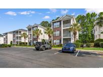 Attractive condo complex with manicured landscaping, palm trees, and convenient parking in a great location at 1298 River Oaks Dr. # 5-I, Myrtle Beach, SC 29579
