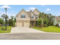 Charming two-story home with stone accents, a two-car garage, and a beautifully landscaped front yard at 18 Cyclamen Ct., Murrells Inlet, SC 29576