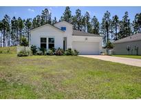 Charming single-story home with white siding, manicured lawn, and attached two-car garage at 212 Carolina Lakes Blvd., Myrtle Beach, SC 29588