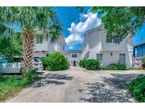 Charming exterior of connected home with concrete drive and mature landscaping at 2309 Withers Dr. # 5, Myrtle Beach, SC 29577