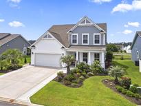 Charming home featuring a two-car garage, manicured lawn, and delightful landscaping at 2572 Brescia St., Myrtle Beach, SC 29579