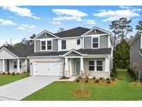 Charming two-story home with white brick, gray accents, manicured lawn and an attached garage at 2610 Tranquility Loop, Longs, SC 29568