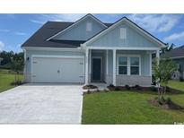 Charming single-Gathering home with a two-car garage, light blue siding, and manicured lawn at 2708 Tranquility Loop, Longs, SC 29568