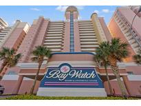 View of the Bay Watch Resort & Conference Center with tropical landscaping in front at 2801 S Ocean Blvd. # 941, North Myrtle Beach, SC 29582