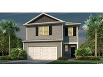 Two-story home features gray siding, black shutters, a white garage door and is surrounded by lush, tropical landscaping at 3591 Ashridge Way, Conway, SC 29526