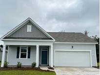 Charming single-story home with a two-car garage, and a welcoming front entrance at 3599 Ashridge Way, Conway, SC 29526