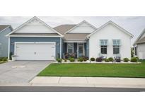 Charming single-Gathering home featuring a two-car garage, lovely landscaping, and a welcoming front porch at 383 Mikita Dr., Surfside Beach, SC 29575