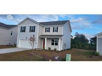 Charming two-story home features a classic design and well-maintained landscaping at 4013 Elmridge Ct., Conway, SC 29526